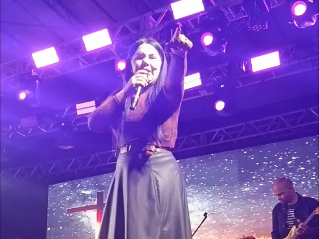 Cantora no palco do Centro de Eventos durante o louvor da 1ª Marcha